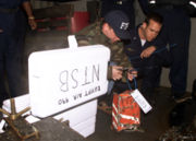 An FBI Agent tags the cockpit voice recorder from EgyptAir Flight 990 on the deck of the USS Grapple (ARS 53) at the crash site on November 13, 1999.