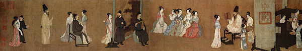 Half-section of the Song Dynasty (960–1279) version of Night Revels of Han Xizai, original by Gu Hongzhong; the painting shows musicians entertaining guests in a 10th century household. In the center are three female musicians playing guan, two female musicians playing transverse bamboo flutes, and a male musician playing a wooden clapper called paiban.