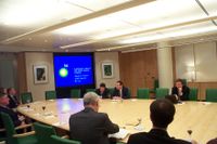Chief Scientist of BP, Steven Koonin (top right, with laptop), speaks about the energy scene in the boardroom in 2005.
