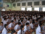 Students having assembly in the hall of a Singapore secondary school.