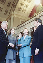 Hillary Clinton re-enacts being sworn in as a U.S. Senator by Vice President Gore as Bill and Chelsea Clinton observe.