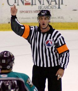 An ice hockey referee is responsible for assessing most penalties during a game.