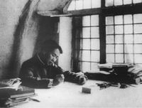 Mao in 1938, writing On Protracted War