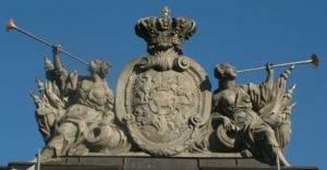 Polish–Lithuanian Commonwealth coat of arms. Ciołek i.e. Stanislaus II August coat of arms is placed in the middle of the shield. The sculpture is situated on guardhouse in Poznań.