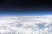 Atmospheric gases scatter blue light more than other wavelengths, giving the Earth a blue halo when seen from space.