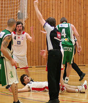 The referee signals that a foul has been committed.