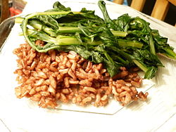 A plate of sauteed dandelion greens, with Wehani rice