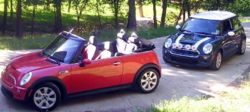 A 2005 MINI Cooper S Convertible (Hot Orange/Black) and a 2003 MINI Cooper S (British Racing Green/White)