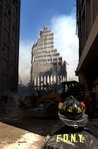 A New York City firefighter looks up at the remains of the South Tower.