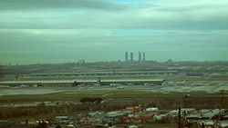 Partial panoramic view of the northernmost part of Madrid. In the image, the new Terminal 4 of Barajas Airport, with the skyline of the Cuatro Torres Business Area in the background.