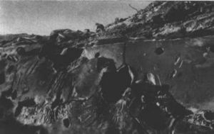 A destroyed German bunker, showing shell impacts in its steel plating