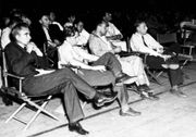 A group of physicists at a wartime Los Alamos colloquium. In the front row are Norris Bradbury, John Manley, Enrico Fermi, and J.M.B. Kellogg (L-R). Oppenheimer is in the second row on the left; to the right in the photograph is Richard Feynman.
