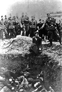 A member of Einsatzgruppe D killing a Jew who is kneeling before a filled mass grave in Vinnitsa, Ukraine, in 1942. The back of the photo is inscribed "The last Jew in Vinnitsa"