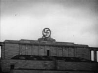 The US army blows up the swastika atop the Nazi Party rally ground (Zeppelin field) in Nuremberg.