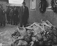 Senator Alben W. Barkley, a member of the US Congressional Nazi crimes committee visiting Buchenwald concentration camp shortly after its liberation.