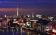 Berlin along the Spree river and the TV tower by night.