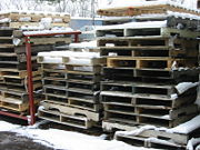 A stack of wooden pallets awaits reuse or recycling.