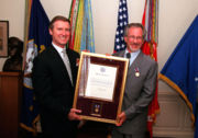 Spielberg with a public service award from US Secretary of Defense William Cohen, 1999