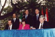 From left to right: (standing) President Carlos Salinas, President Bush, Prime Minister Brian Mulroney; (seated) Jaime Serra Puche, Carla Hills, and Michael Wilson at the NAFTA Initialing Ceremony, October 1992