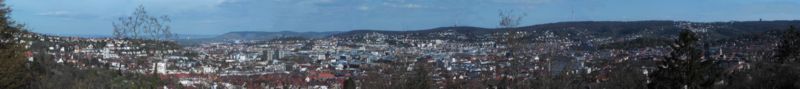 Panorama of Stuttgart looking South East. From the Neckar valley on the left the city rises to the city centre, backdropped by high woods to the south (television tower). Stuttgart South and West are to the right.
