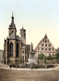 The Protestant  Stiftskirche (originally built in 1170) pictured around 1900. In the foreground: the memorial on Schiller square.