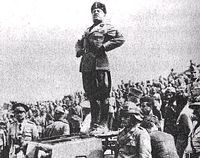 Il Duce standing on top of a tank