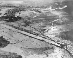 Aerial view of Henderson Field on Guadalcanal, late August 1942. The view looks northwest with the Lunga River and Lunga Point at the top of the image.