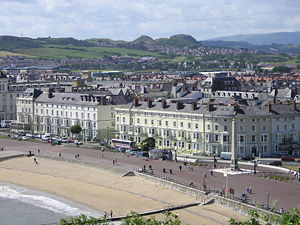 Llandudno South Parade (on the north shore) viewed from the Great Orme, with the twin mounds of Deganwy Castle in the distance