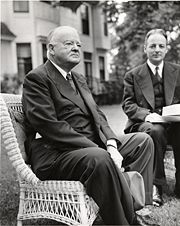 Hoover seated (left) with Arthur Flemming at Ohio Wesleyan University.