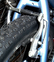 Linear-pull brake on rear wheel of a mountain bike