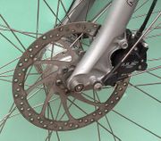 A front disc brake, mounted to the fork and hub