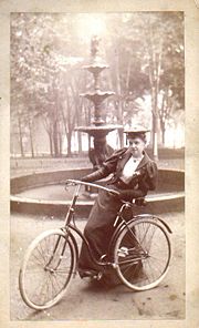 Woman with bicycle, 1890s