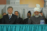 Stephen Harper (left) seated with Mirza Masroor Ahmad (right) at the grand opening of the largest mosque in Canada, Baitunnur, in Calgary, on July 5, 2008