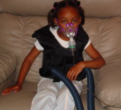A typical breathing treatment for cystic fibrosis, using a mask nebuliser and the ThAIRapy Vest