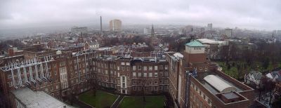 View of Belfast from The Ashby Building, part of QUB. The David Keir Building of Queen's University is in the foreground. The yellow façade of Belfast City Hospital is visible in the centre background, with the city's current tallest building Windsor House in the right background.