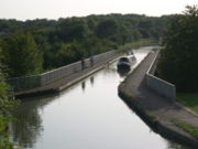 the Grand Union Canal passes over Grafton Street at Bradwell via the modern Bradwell Aqueduct