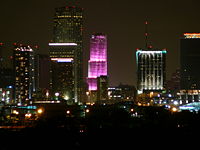 The Bank of America  Tower lit hot neon pink, one of the colors that has become the epitome of Miami's fashion industry