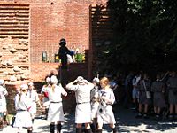 Polish Girl Guides by the Monument to Small Partisan in Warsaw