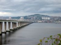 Dundee viewed across the Tay estuary from the southern side. The hill in the background is Dundee law which is situated approximately in the centre of the city. To the left is the Tay Road Bridge