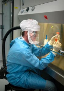 CDC scientist working on influenza under high bio-safety conditions