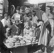 Bread-seller in front of a bakery, Damascus, 1910.