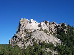 Mt. Rushmore, showing the full size of the mountain and the scree of debris from construction.