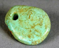 Trade in turquoise crafts, such as this freeform pendant dating from 1000–1040 CE, is believed to have brought the Ancestral Puebloans of the Chaco Canyon great wealth.