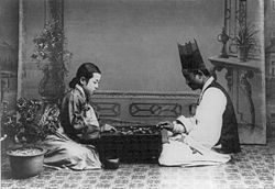 Korean players, in traditional dress, play in a photograph dated between 1910 and 1920.