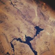 Lake Mead from space, November 1985. North is facing downward to the right. The Colorado River can be seen leading southward away from the lake on the top left. Hoover Dam is located where the river meets the lake.