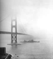 The USS San Francisco steams under the Golden Gate Bridge in 1942, during World War II.