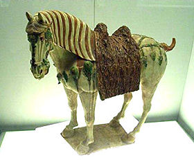 A Tang Dynasty tri-color glazed figurine of a horse
