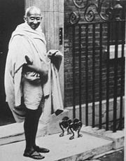 Gandhi in front of Number 10 after meeting with Ramsey MacDonald in 1931 to discuss India's independence.  With the advent of photography, pictures like this became common place; it became obligatory that Prime Ministers, heads of state, celebrities and ordinary people pose in front of Number 10's famous door.