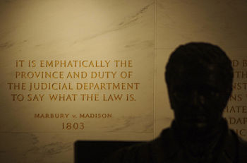 Inscription on the wall of the Supreme Court Building from Marbury v. Madison, in which Chief Justice John Marshall (statue, foreground) outlined the concept of judicial review.