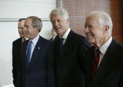 President George W. Bush (second from left), walks with, from left, former Presidents George H.W. Bush, Bill Clinton, and Jimmy Carter during the dedication of the William J. Clinton Presidential Center and Park in Little Rock, Arkansas, November 18, 2004